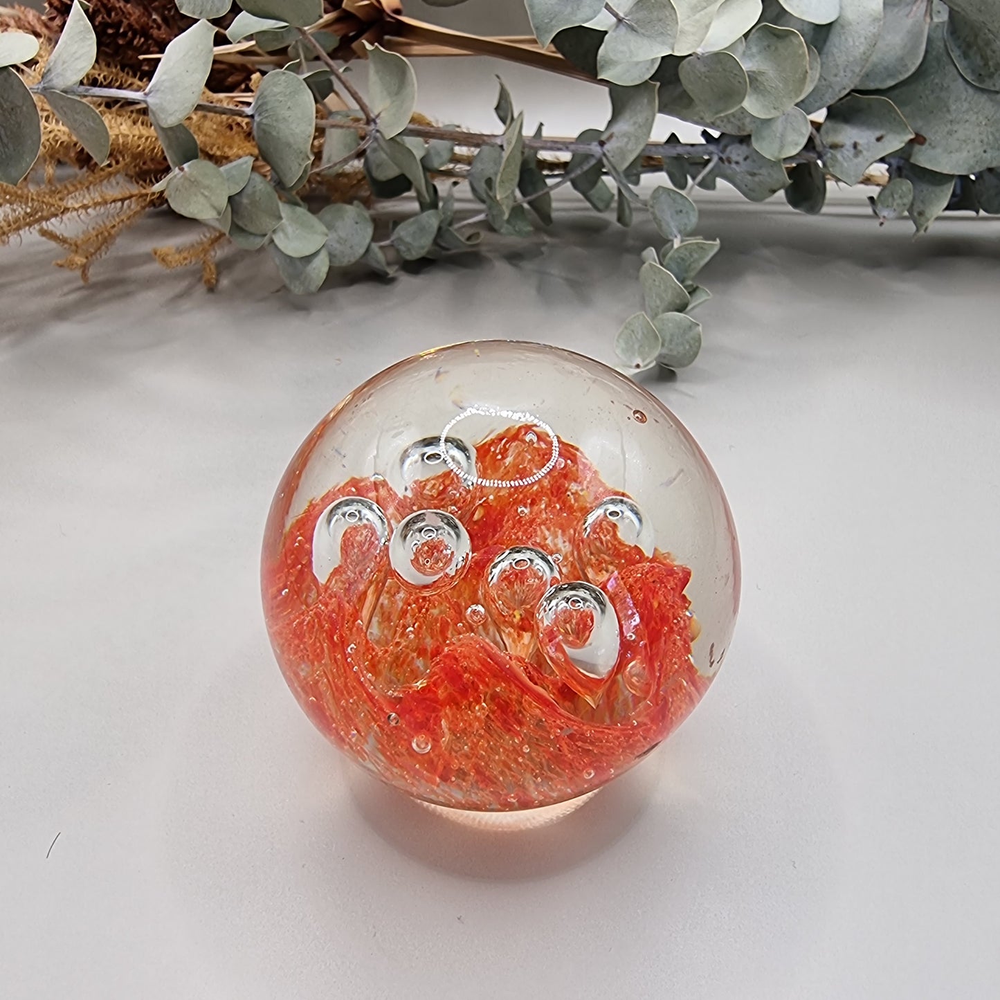 Vintage orange controlled bubble glass paperweight