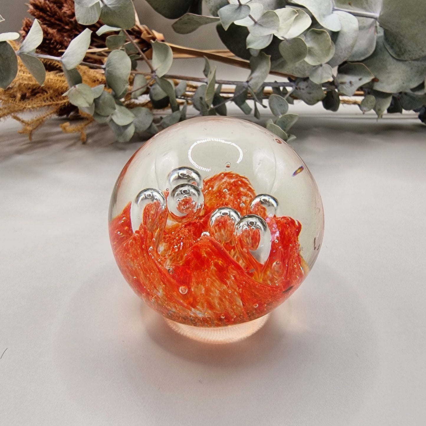 Vintage orange controlled bubble glass paperweight