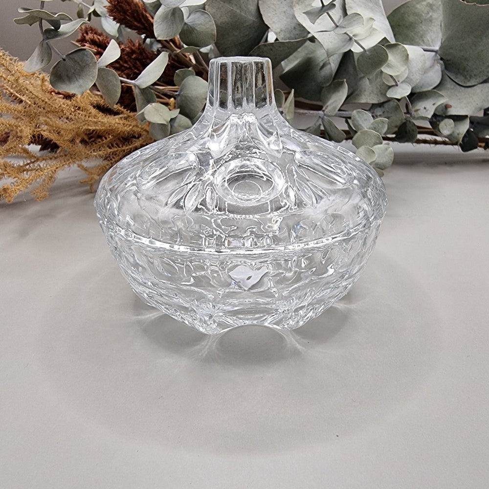 Vintage cut glass trinket box with tall lid and decorative pattern.
