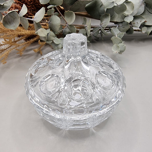 Vintage cut glass trinket box with tall lid and decorative pattern.