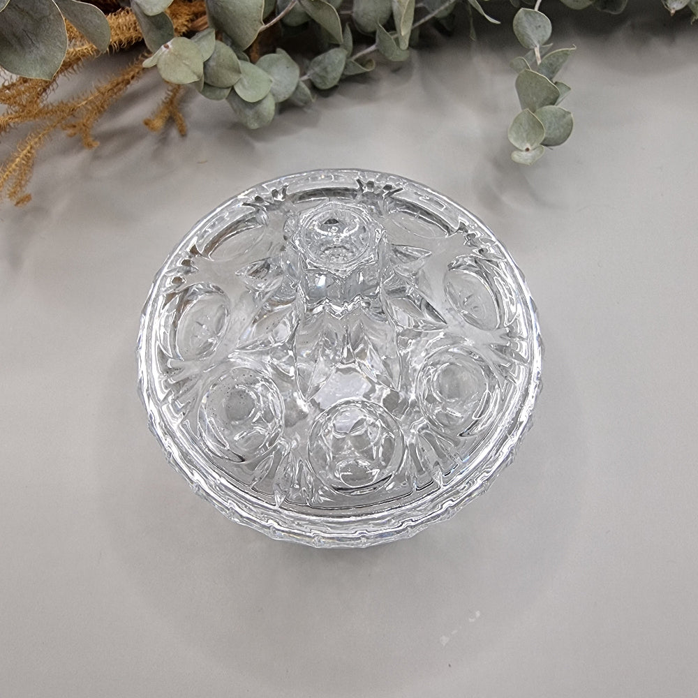 Vintage cut glass trinket box with tall lid and decorative pattern.