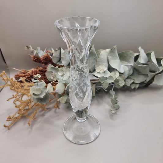 Crystal bud vase with swirl cut design and flared rim on a footed base.