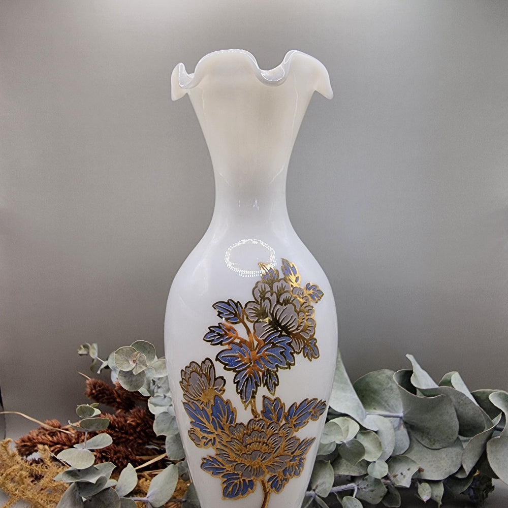 Tall white milk glass vase with gold and blue floral detail and ruffled top
