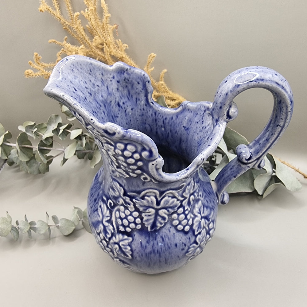Blue pitcher with raised grape pattern