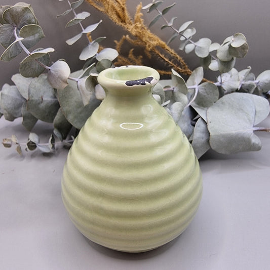 Small green ribbed ceramic vase with distressed detail