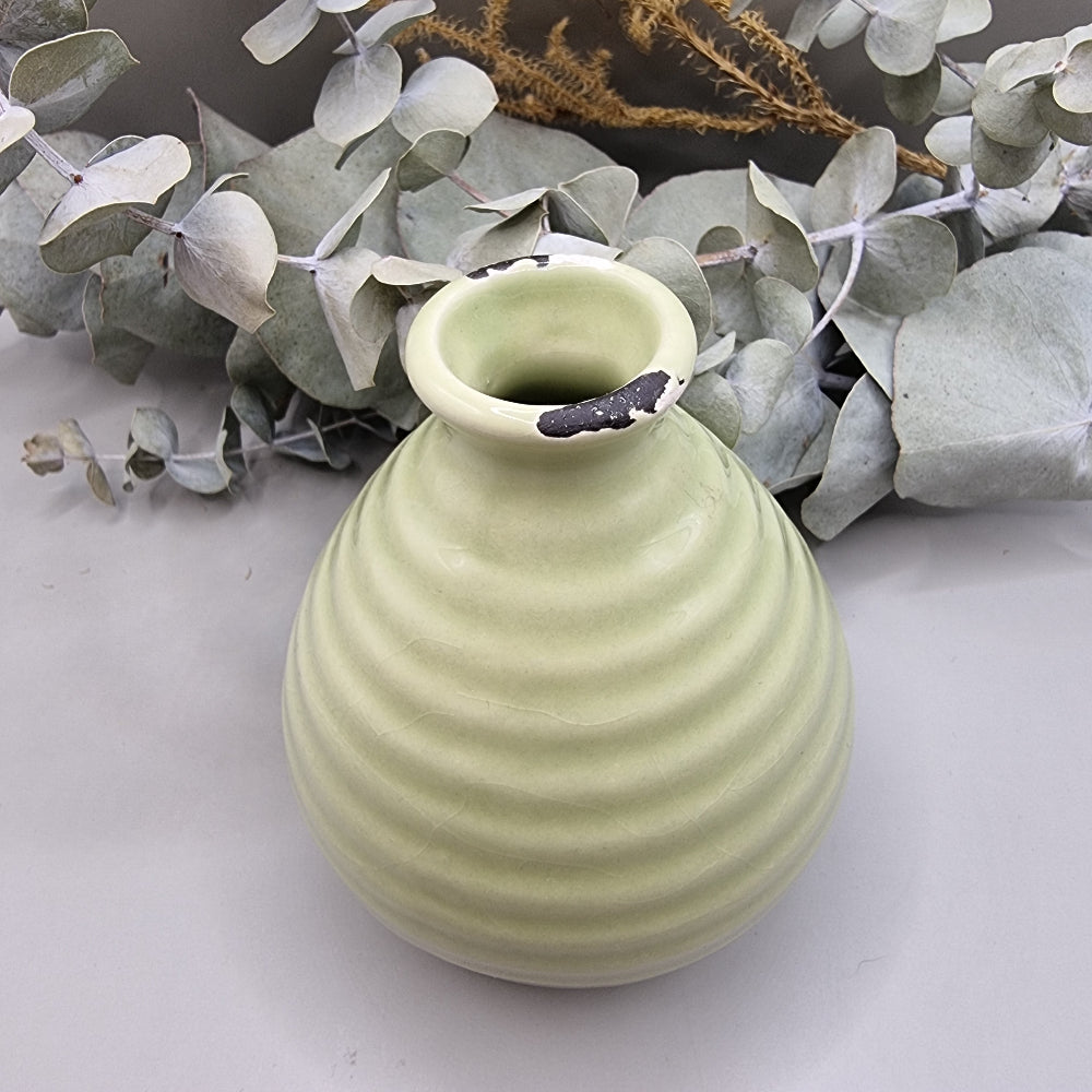 Small green ribbed ceramic vase with distressed detail