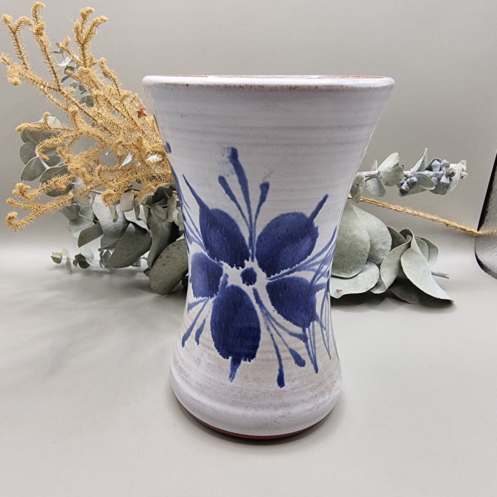 Handcrafted ceramic vase with cobalt blue flower design on off-white glaze.