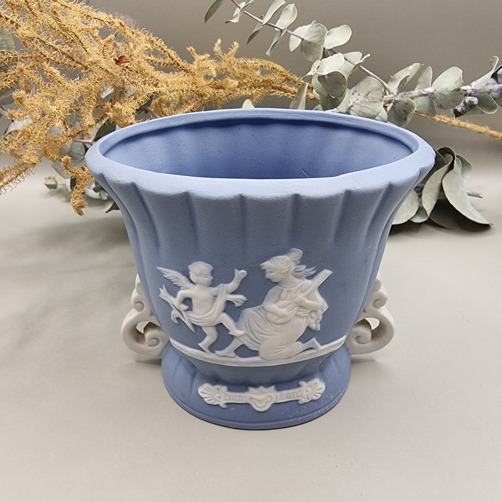 Blue vase with white cherub and woman playing lute in raised relief, Japanese jasperware style.