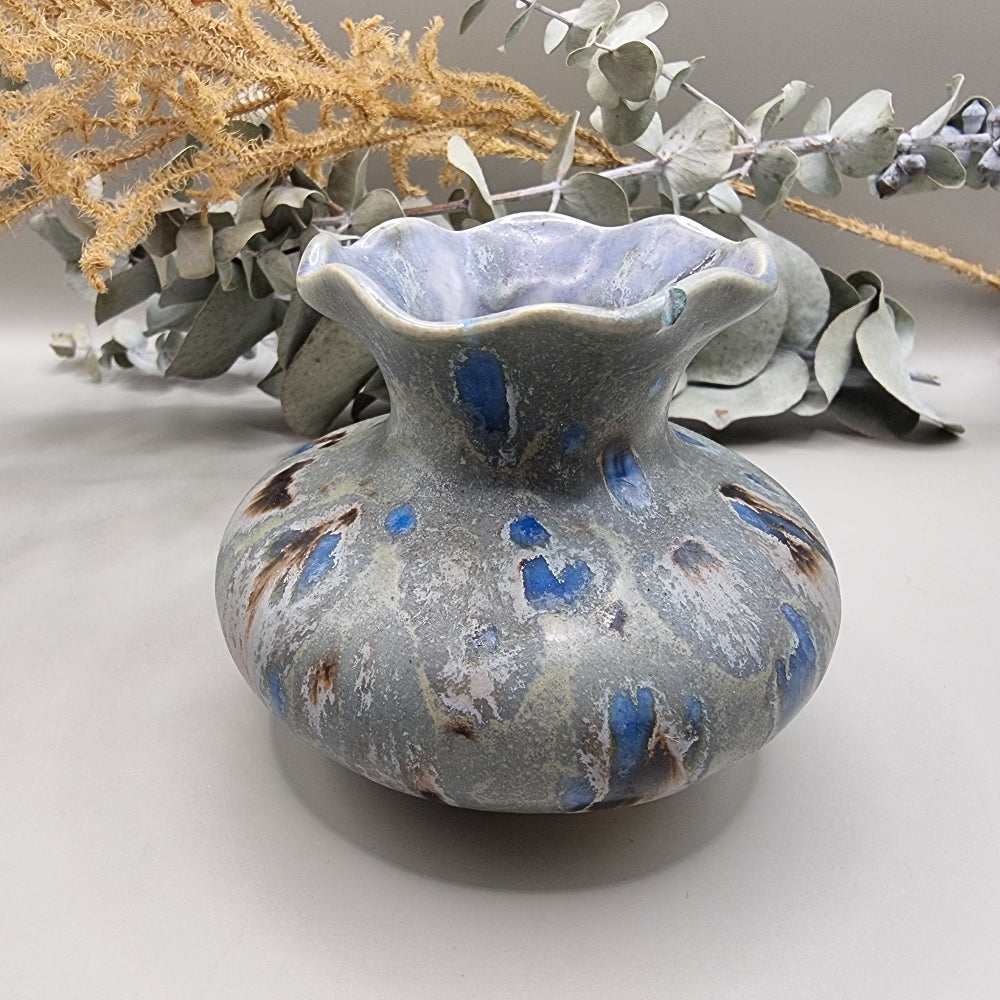 Ruffled rim ceramic vase with blue and earthy glaze, small chip on rim.