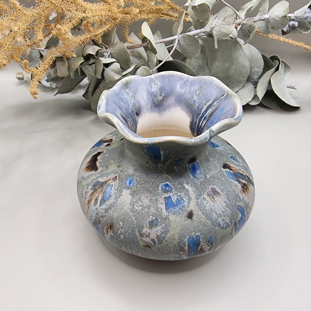 Ruffled rim ceramic vase with blue and earthy glaze, small chip on rim.