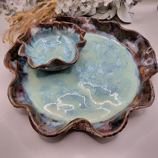 One-piece ceramic dip platter with ruffled edge and built-in bowl, sea-toned glaze and textured base.