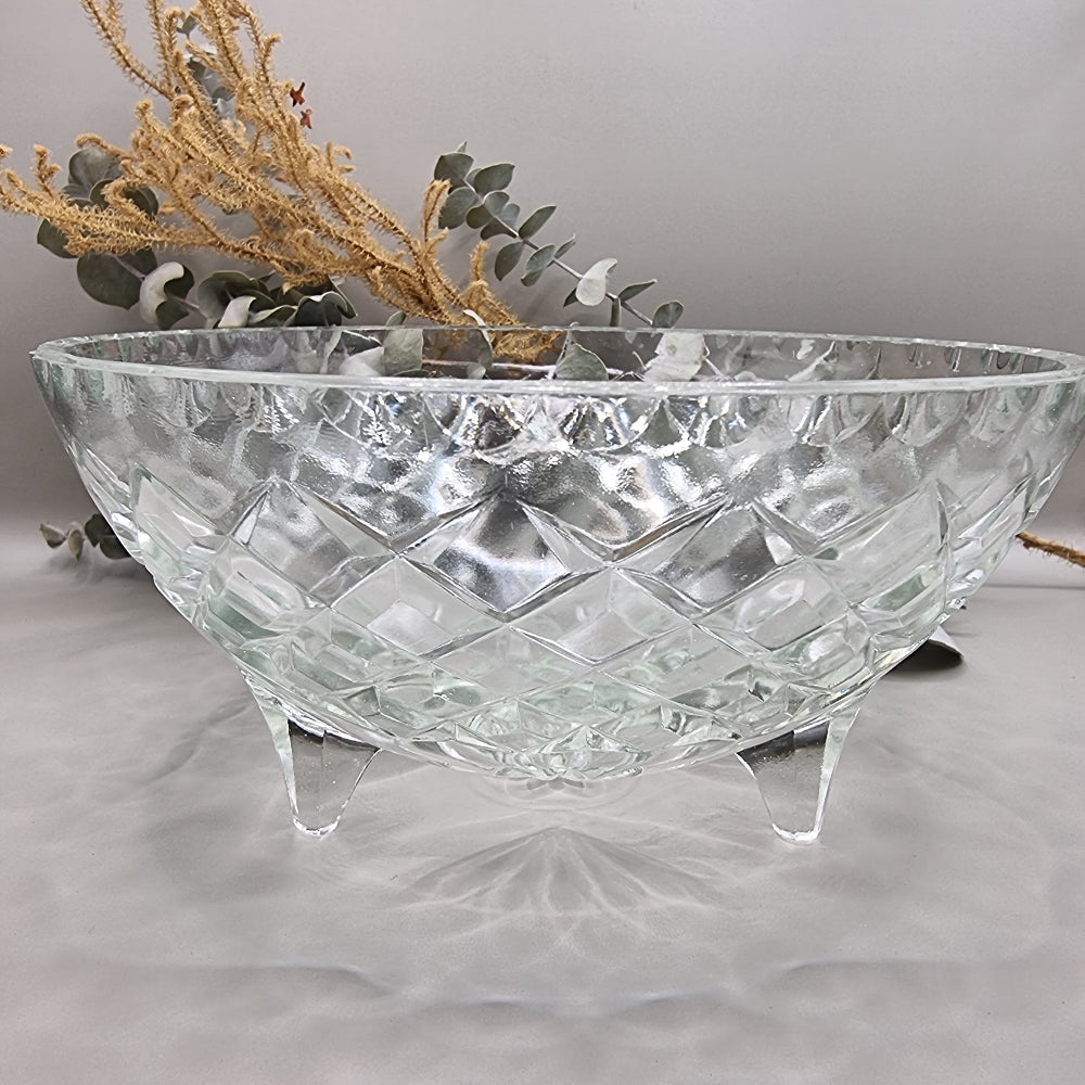 Footed pressed glass bowl with diamond pattern and starburst base.