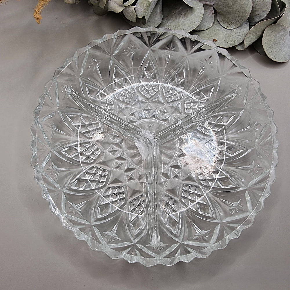 Three-section pressed glass dish with starburst and diamond pattern
