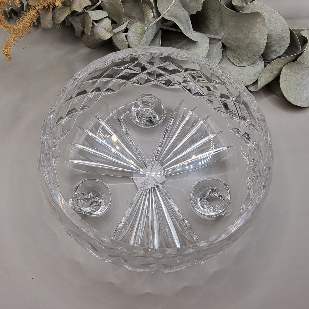 Small footed pressed glass bowl with diamond pattern and scroll feet.