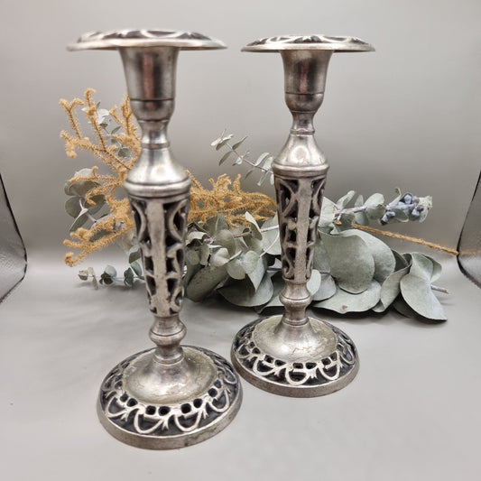 Pair of vintage filigree candle holders with ornate cut-out design