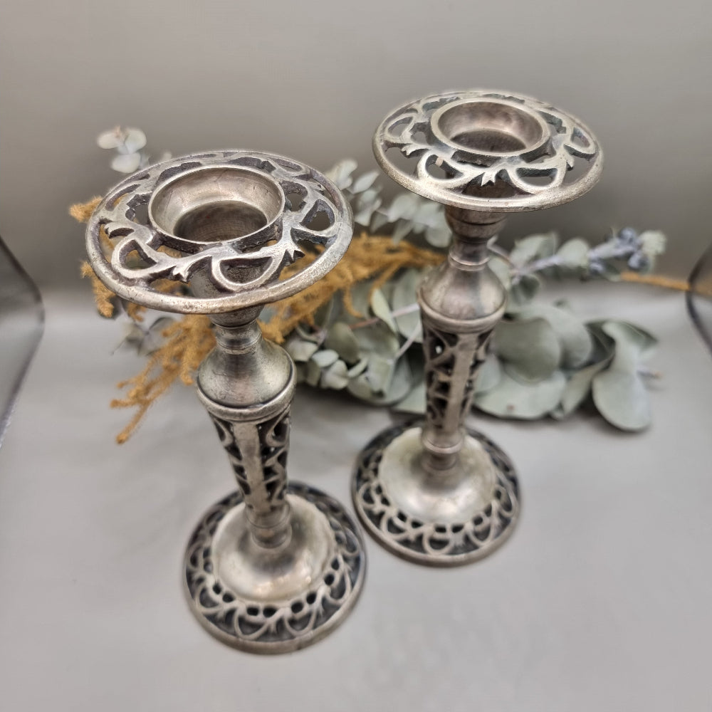 Pair of vintage filigree candle holders with ornate cut-out design