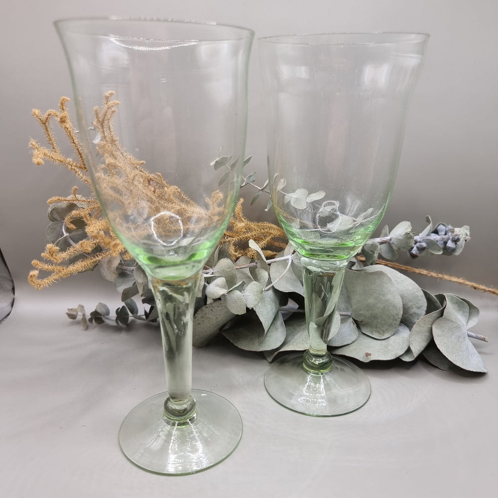 Pair of vintage green-tinted wine glasses with tall stems