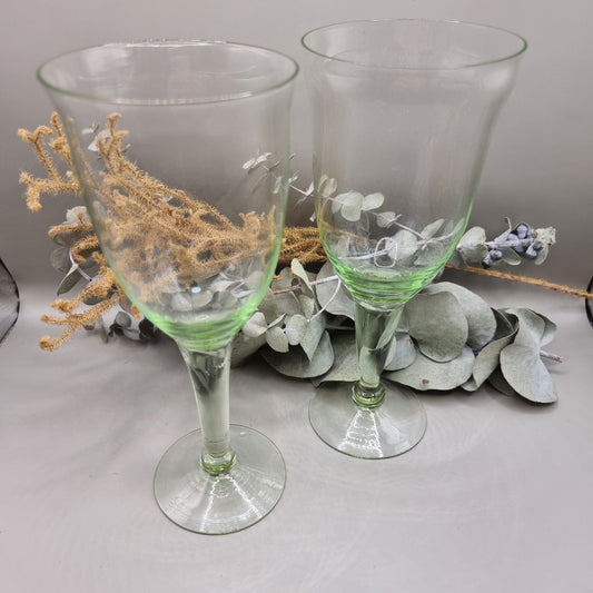 Pair of vintage green-tinted wine glasses with tall stems
