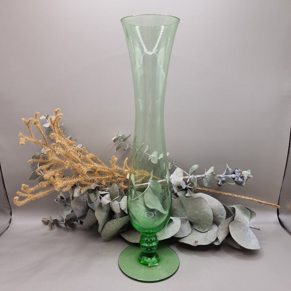 Tall vintage green glass vase with pedestal base and flared top