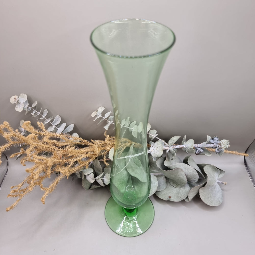 Tall vintage green glass vase with pedestal base and flared top