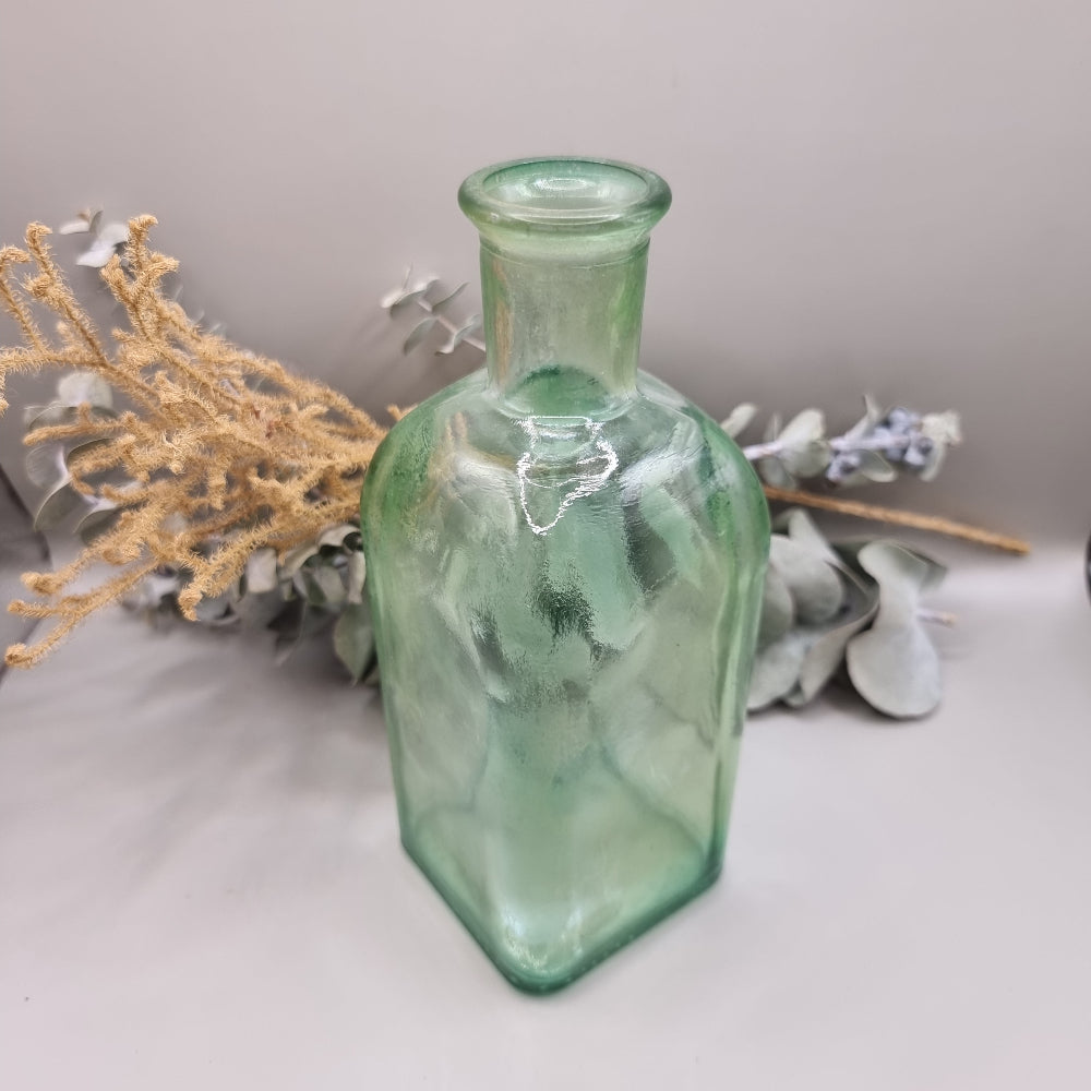 Vintage green glass square bottle with rounded shoulders and pale green tint