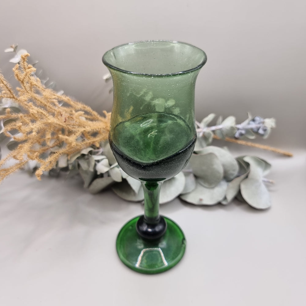 Vintage dark green handblown wine glass with flared rim and bubbled texture