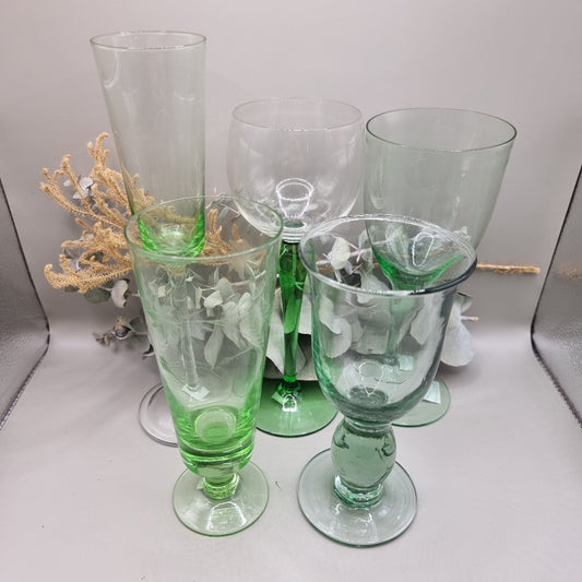 Set of five vintage green glass stemware pieces in assorted shapes