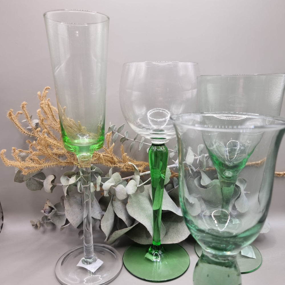 Set of five vintage green glass stemware pieces in assorted shapes