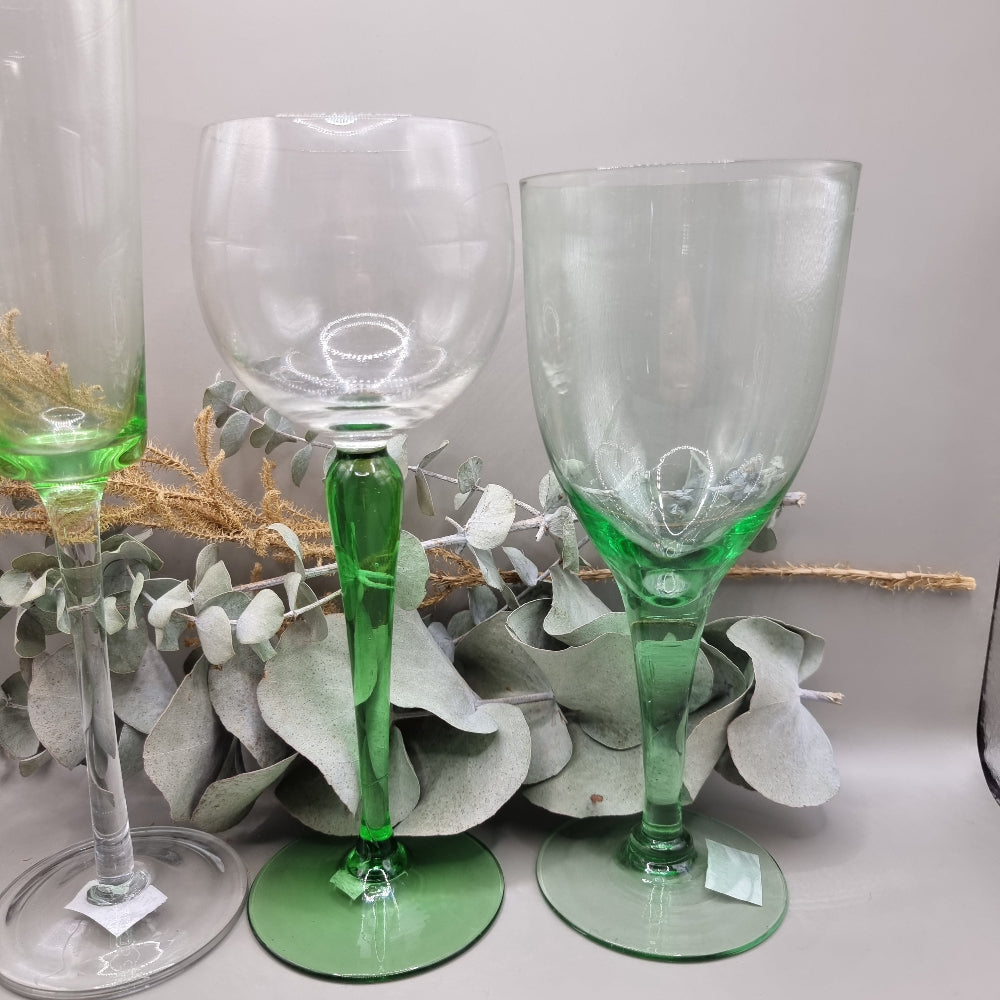 Set of five vintage green glass stemware pieces in assorted shapes