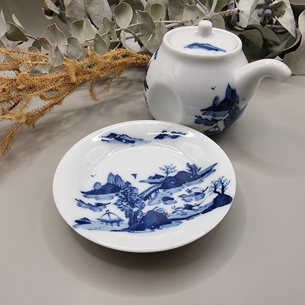 Japanese blue and white sake pot with lid and matching saucer featuring Hill & Water landscape design