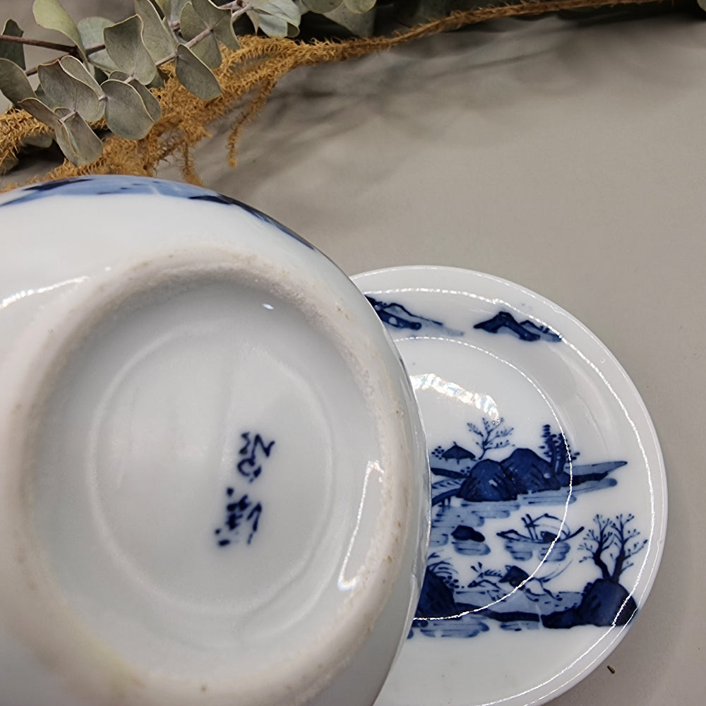 Japanese blue and white sake pot with lid and matching saucer featuring Hill & Water landscape design