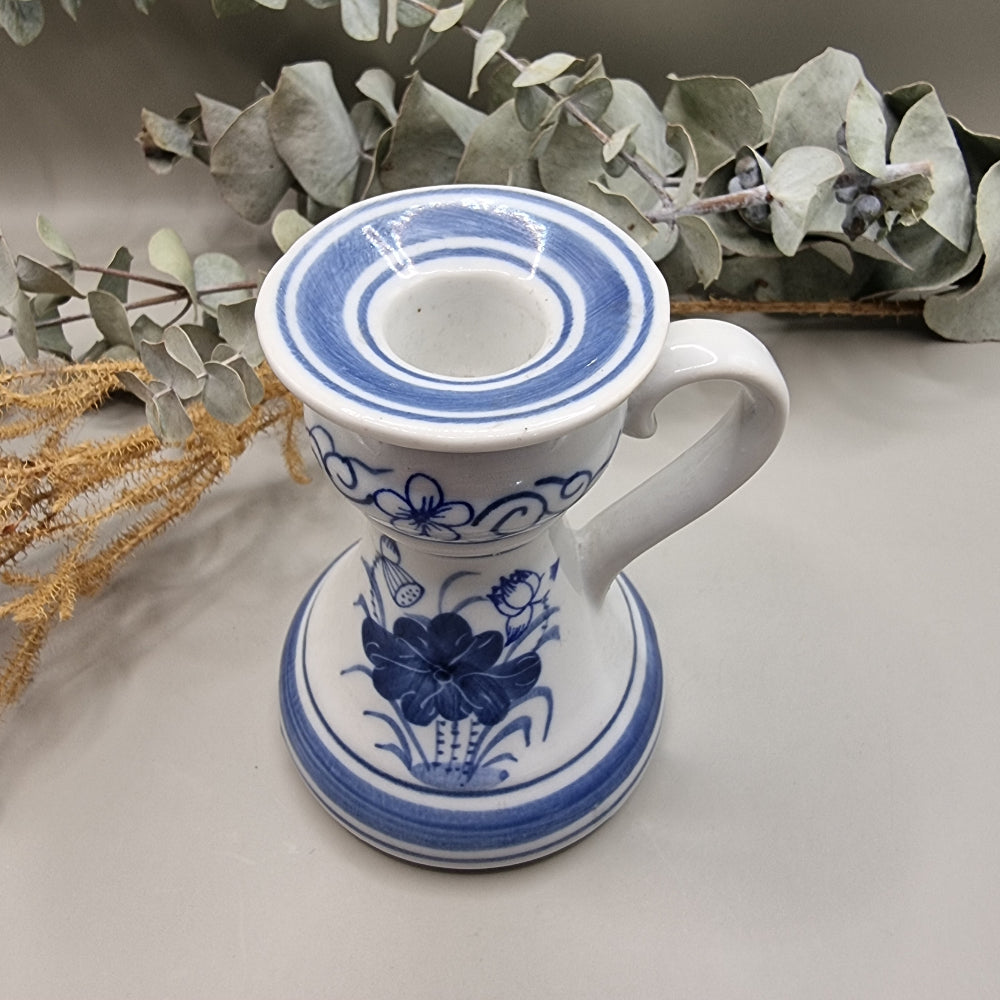 Blue and white ceramic candle holder with handle and floral design, handcrafted in Thailand.