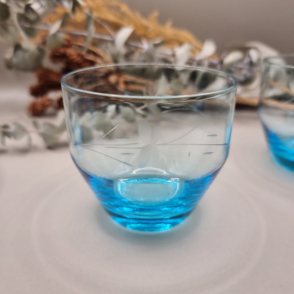Set of 3 aqua blue glass tumblers with etched floral design.