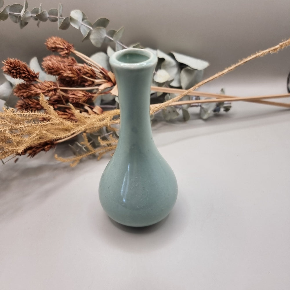 Light blue Korean pottery bud vase with narrow neck and rounded base.