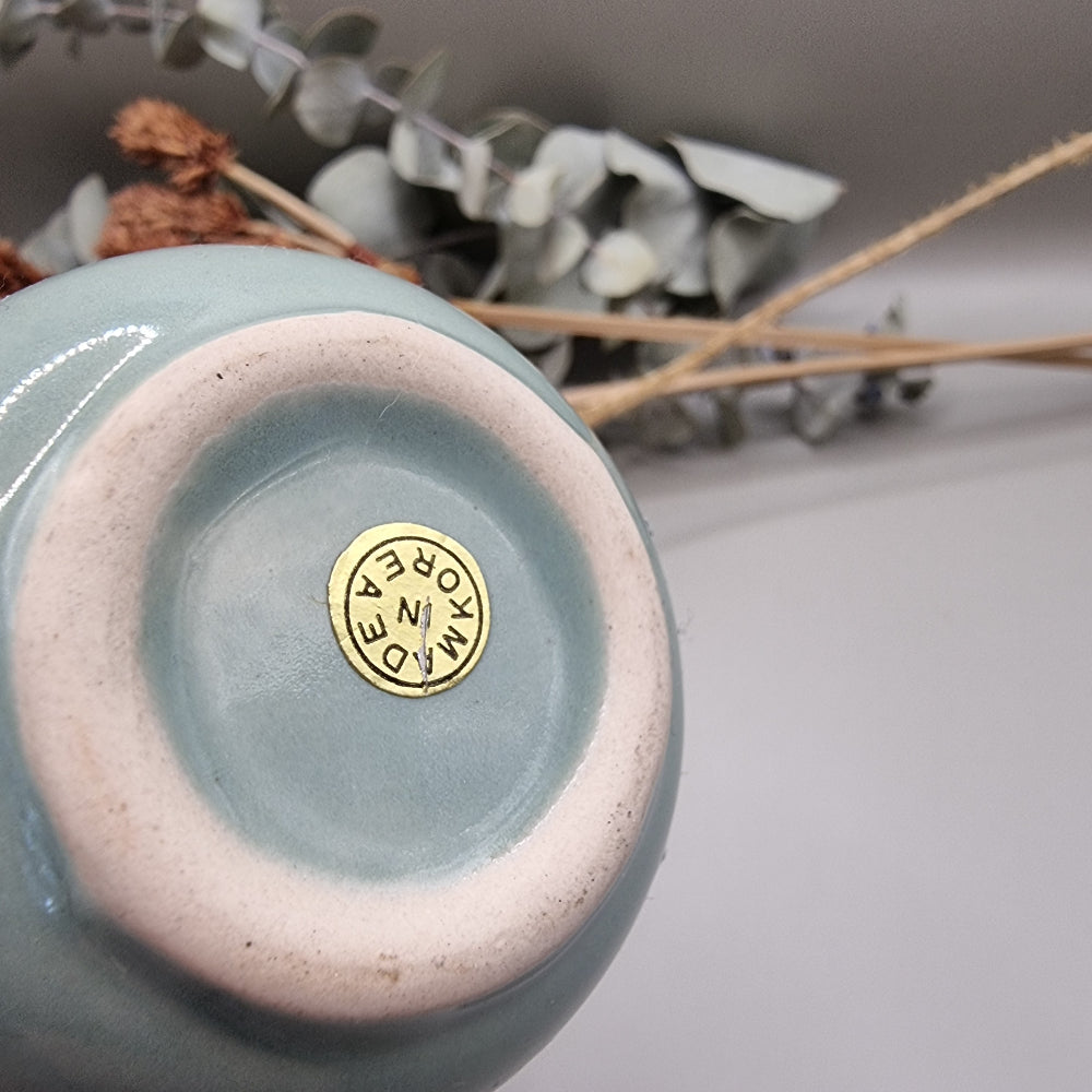 Light blue Korean pottery bud vase with narrow neck and rounded base.