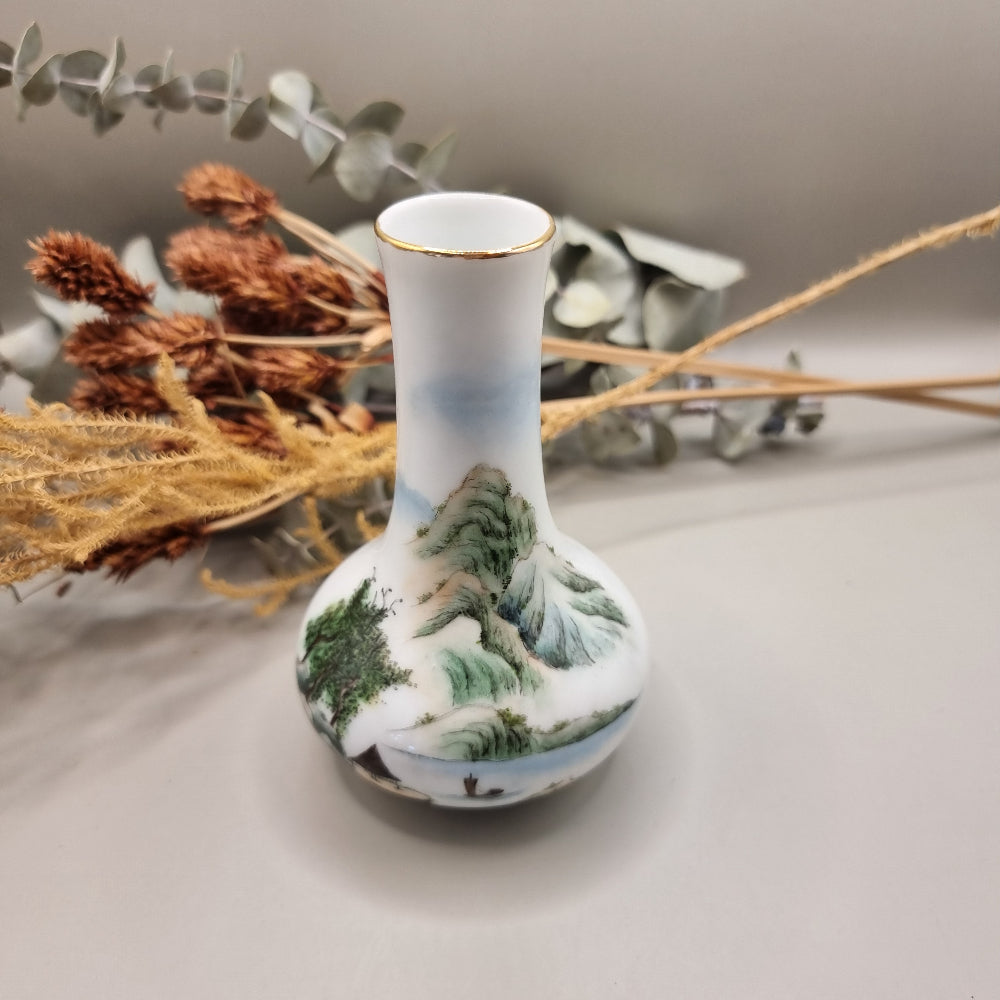 Hand-painted Chinese porcelain bud vase with mountain scene and calligraphy.
