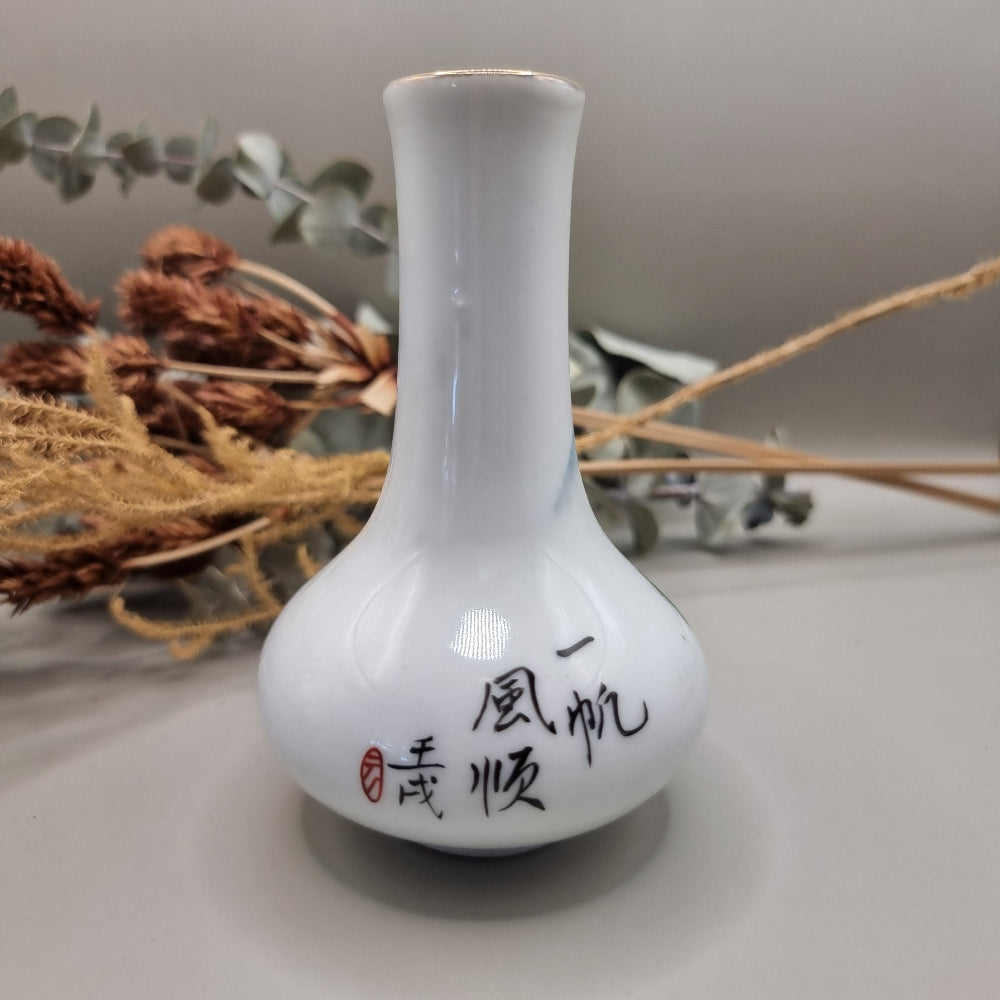 Hand-painted Chinese porcelain bud vase with mountain scene and calligraphy.