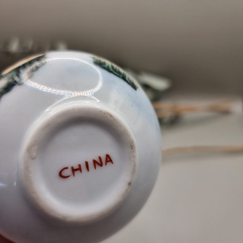 Hand-painted Chinese porcelain bud vase with mountain scene and calligraphy.