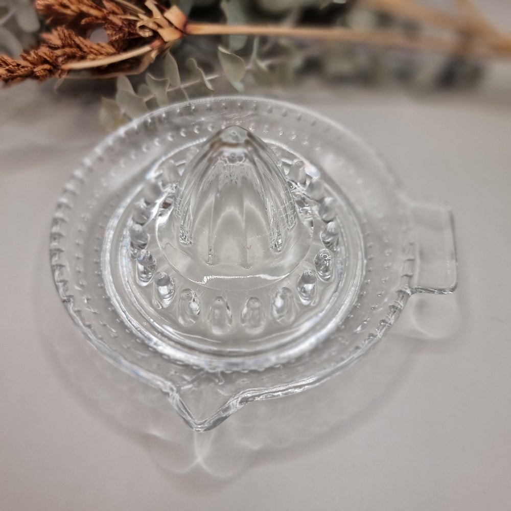Vintage clear glass citrus juicer with spout and seed catcher