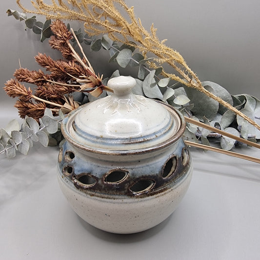 Handmade pottery jar with lid, blue-grey glaze and cutouts, signed FS on base