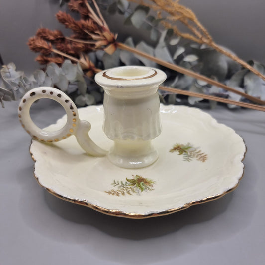 Cream ceramic candle holder with fern design, gold trim, and dotted handle