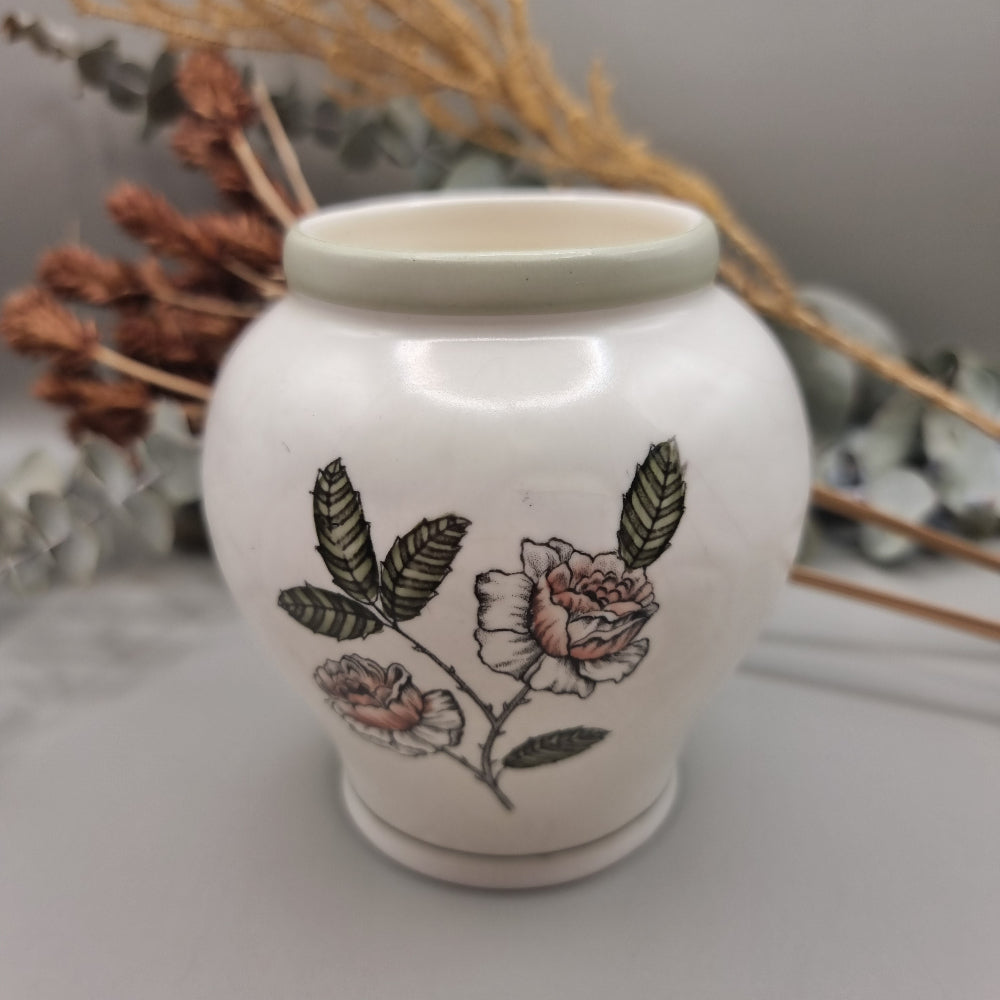 Crown Devon Fieldings vase 1244 with floral and leaf design on creamy ceramic base.