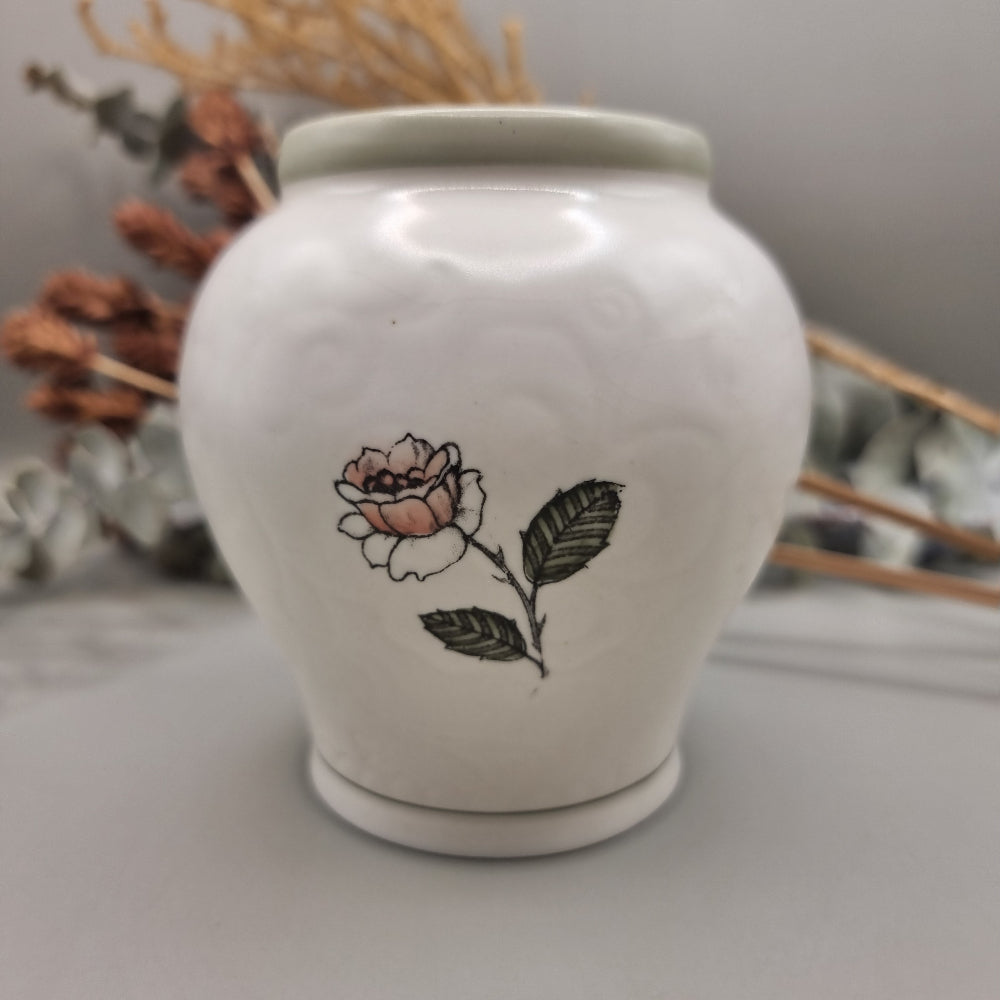 Crown Devon Fieldings vase 1244 with floral and leaf design on creamy ceramic base.