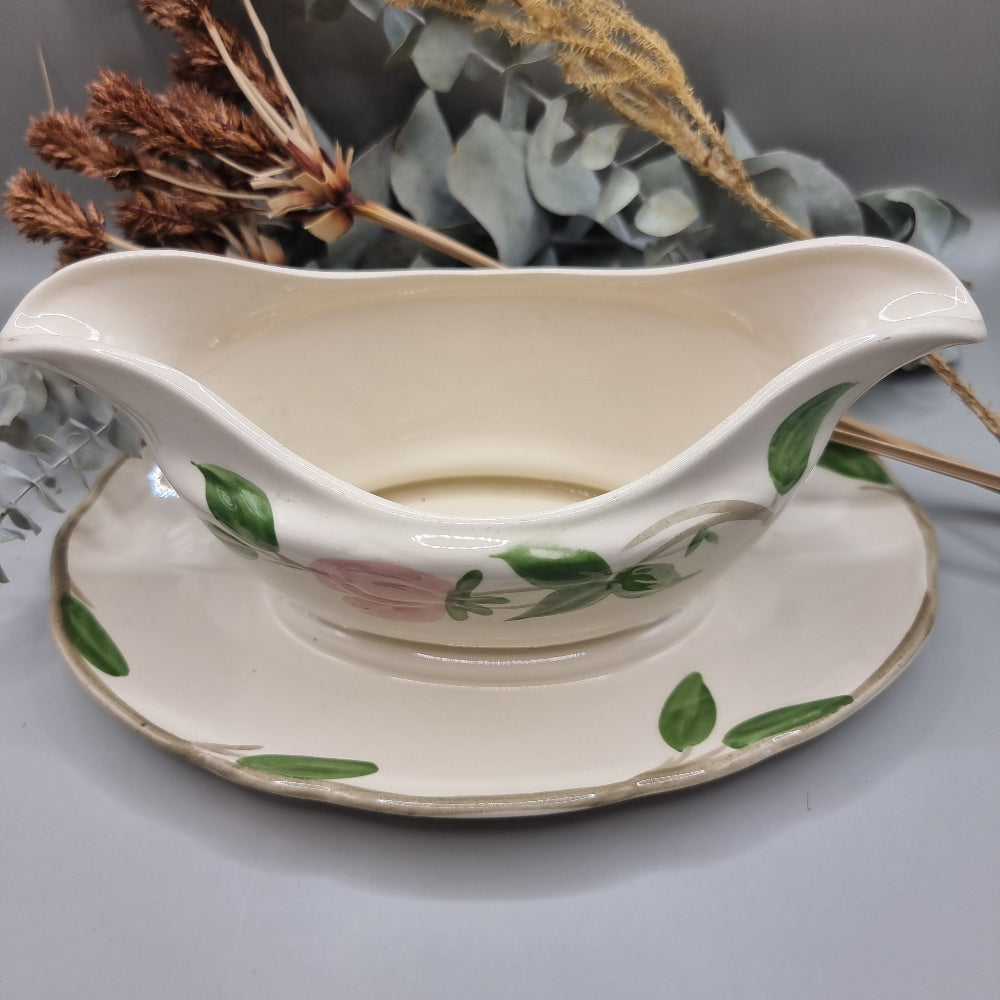 Franciscan “Desert Rose” gravy boat with pink floral pattern and attached underplate.
