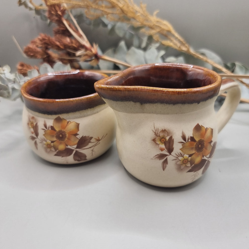 NZ stoneware creamer and sugar set with brown floral design and glaze rim