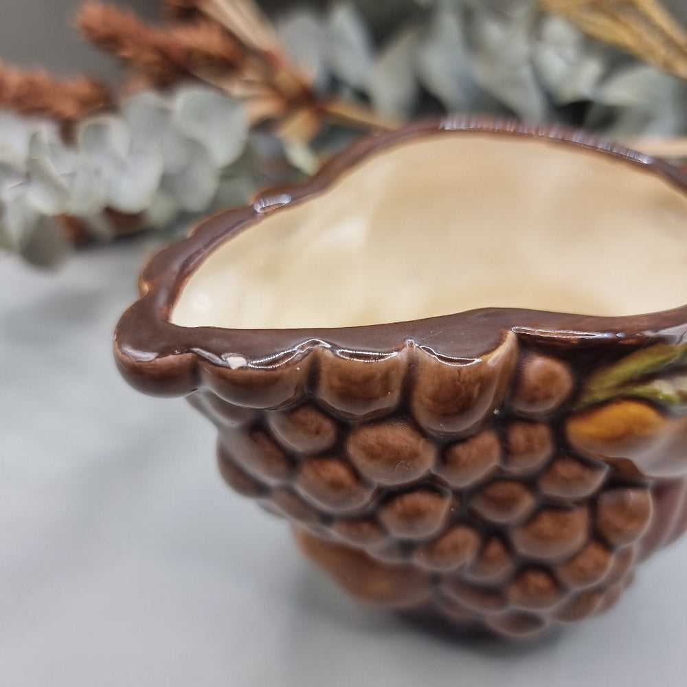 Vintage ceramic jug with raised fruit motif and brown glazed finish