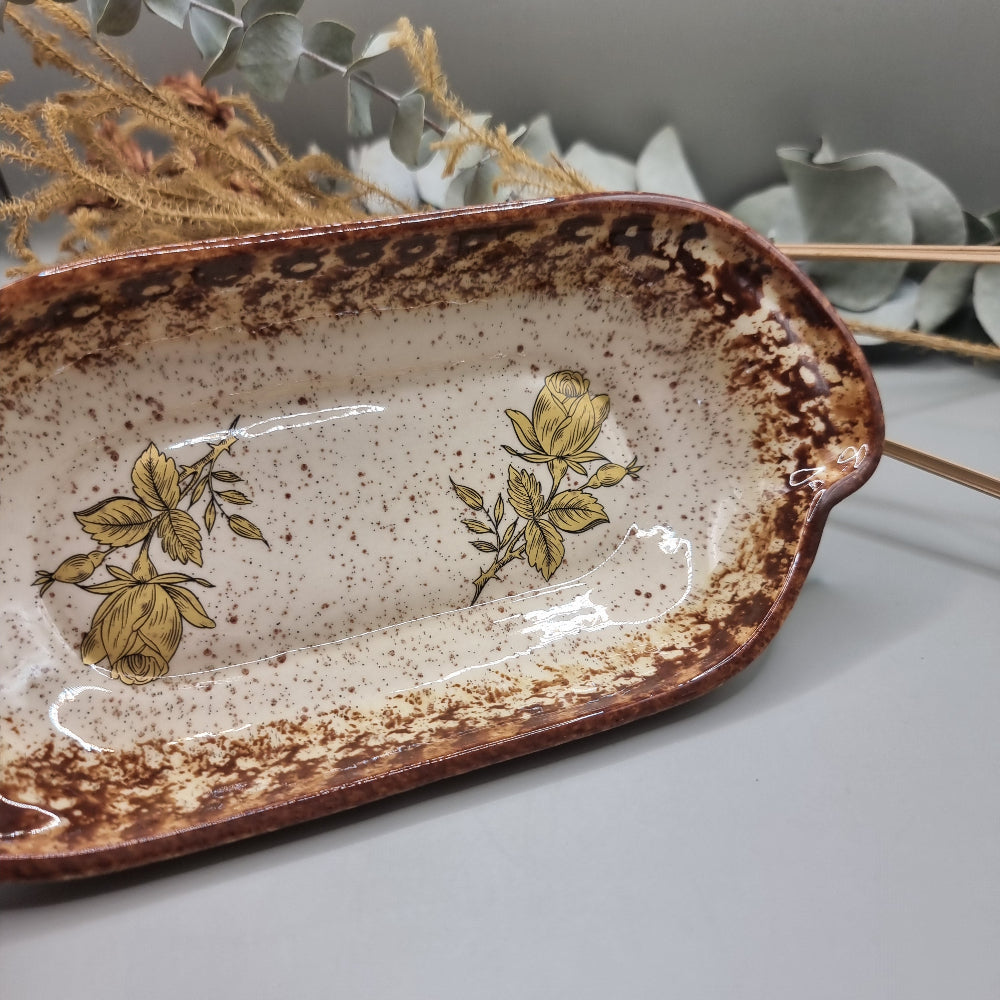 Rectangular speckled stoneware dish with brown glaze and yellow rose floral decals.