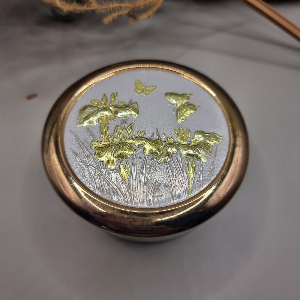 Round lidded trinket box with gold irises and butterfly design in Art of Chokin style