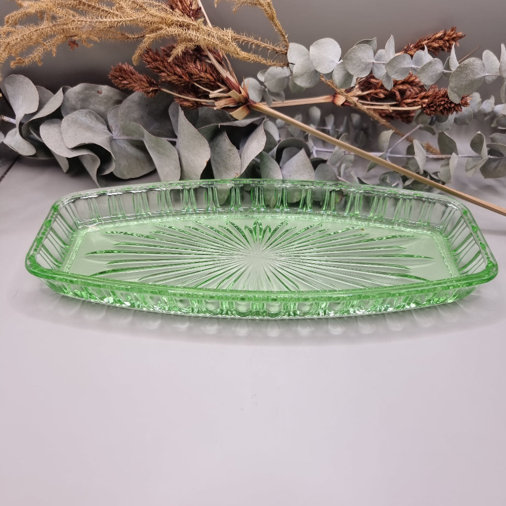Vintage green pressed glass tray with starburst pattern and ribbed edge