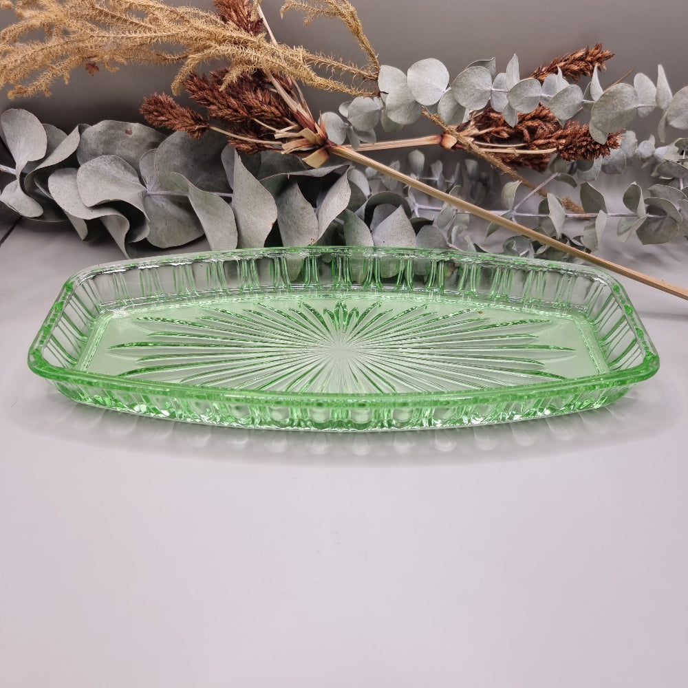 Vintage green pressed glass tray with starburst pattern and ribbed edge